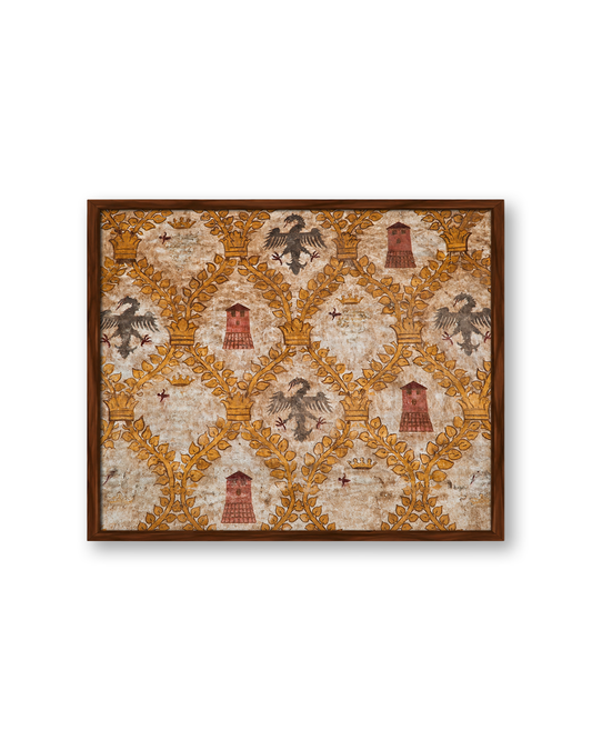 A framed square art print featuring a vintage-style damask pattern with black eagles, gold leaf motifs, and red towers on an aged beige background, enclosed in a dark brown wooden frame.