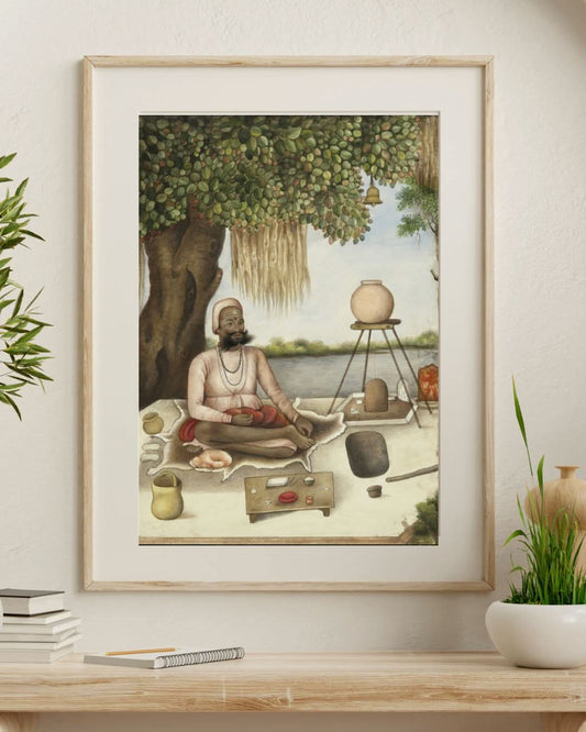 Framed artwork of a meditating figure in a natural setting on a wall above a desk.