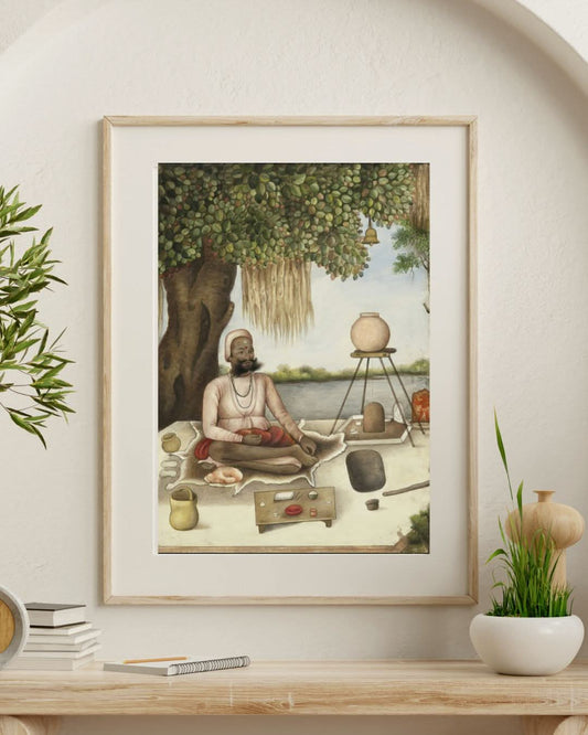 Framed artwork of a man in a meditative pose on a table with decorative items.