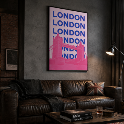A framed London city art print with bold blue text and a pink bridge silhouette hanging on a dark gray wall above a brown leather sofa in a moody, stylishly decorated room.