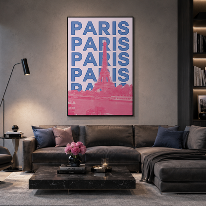 A framed vertical wall art print featuring the word 'PARIS' repeated in blue with a pink Eiffel Tower silhouette and pink lower section, displayed above a dark gray sectional sofa in a modern living room.