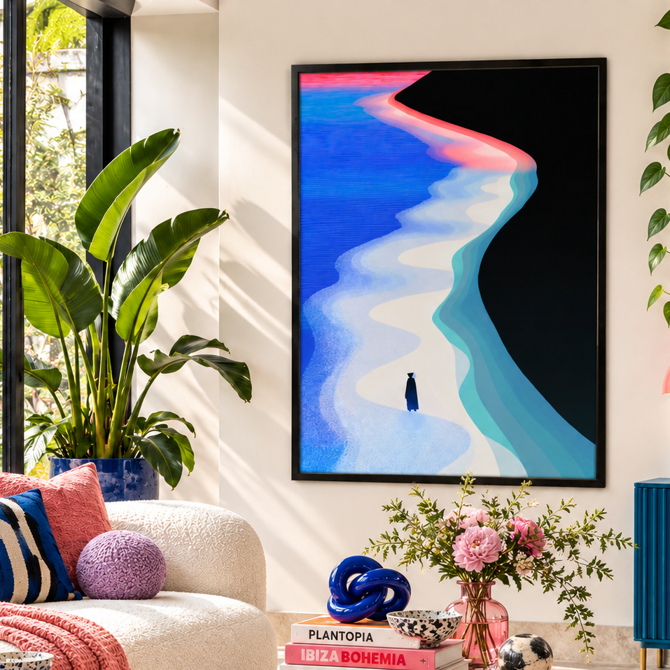 A framed abstract wall art print hangs in a styled living room. The artwork depicts a winding path or shoreline in bright blue, teal, pink, and black, with a small dark figure near the bottom center.