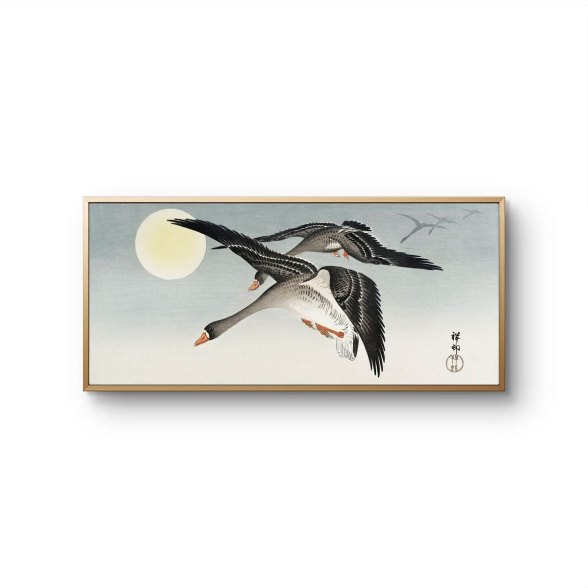 Framed artwork of two geese flying against a moonlit sky