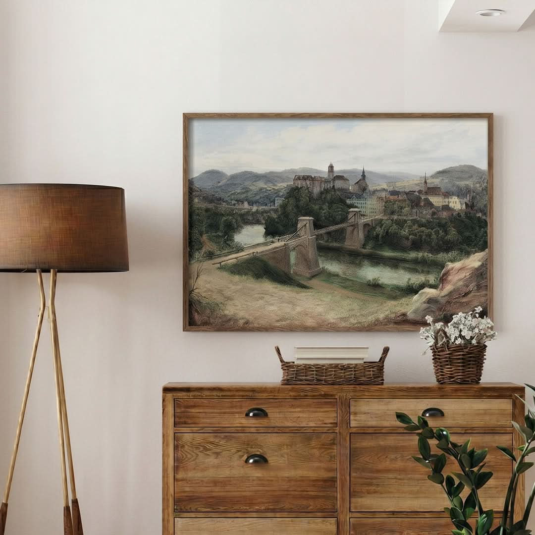 Room interior with a wooden dresser, lamp, and framed landscape painting on the wall.