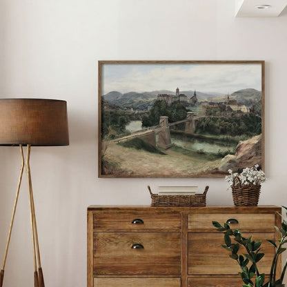 Room interior with a wooden dresser, lamp, and framed landscape painting on the wall.