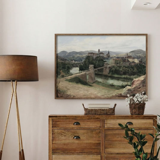 Room interior with a wooden dresser, lamp, and framed landscape painting on the wall.