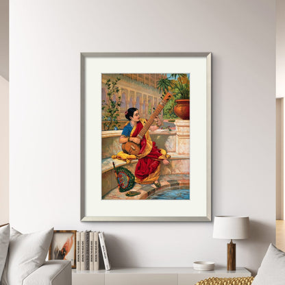 A framed artwork of an Indian woman playing a sitar, displayed on a wall above a sofa in a living room setting.