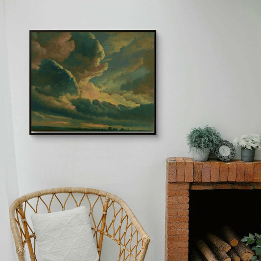 Living room with a wicker chair, fireplace, and framed artwork of a sunset.