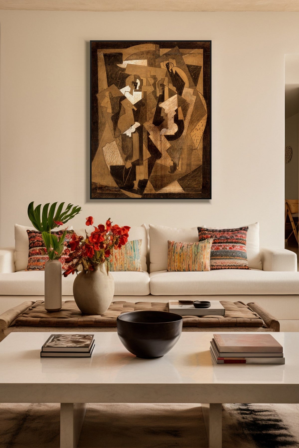 Cubist Conversations art print in a black frame above a cream sofa