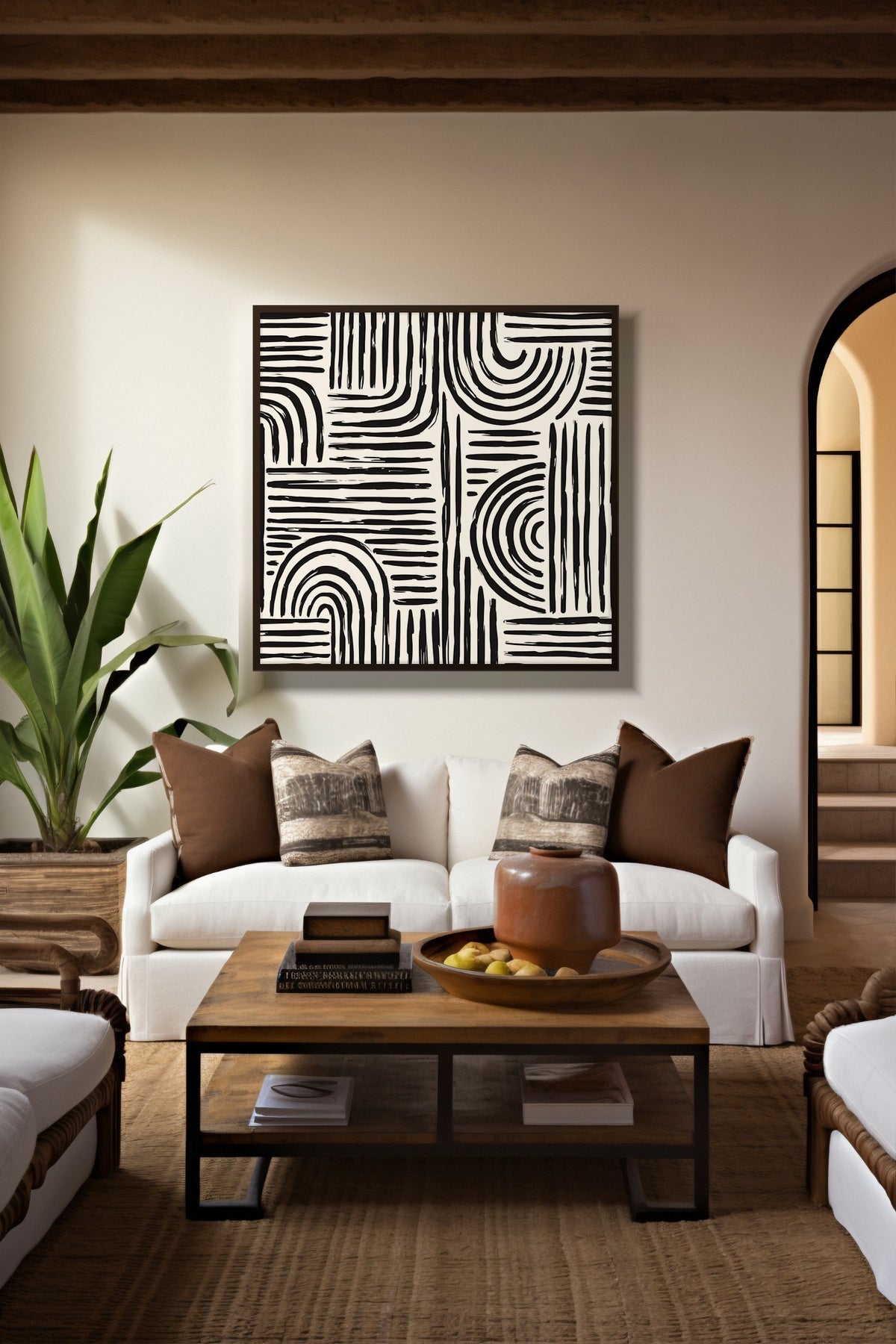 Monochrome Arches line art print framed above a white sofa in a warm living room
