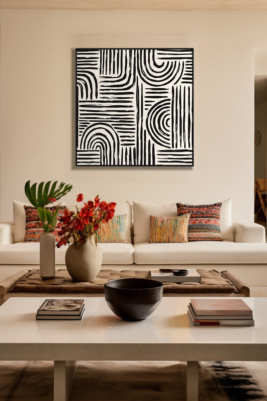 Monochrome Arches black and white print in a black frame above a cream sofa