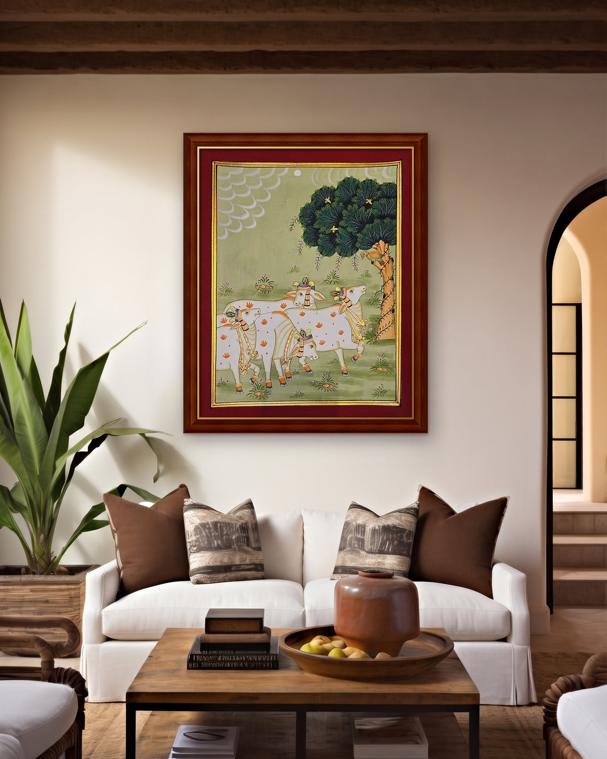 Gaumata Grazing Under the Kadamb - Sage Pichwai styled on a wall in a walnut wood frame (frame sold separately)
