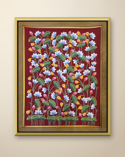 Kamal Van Lotus Garden - Maroon Pichwai shown in a gold metal frame (frame sold separately)