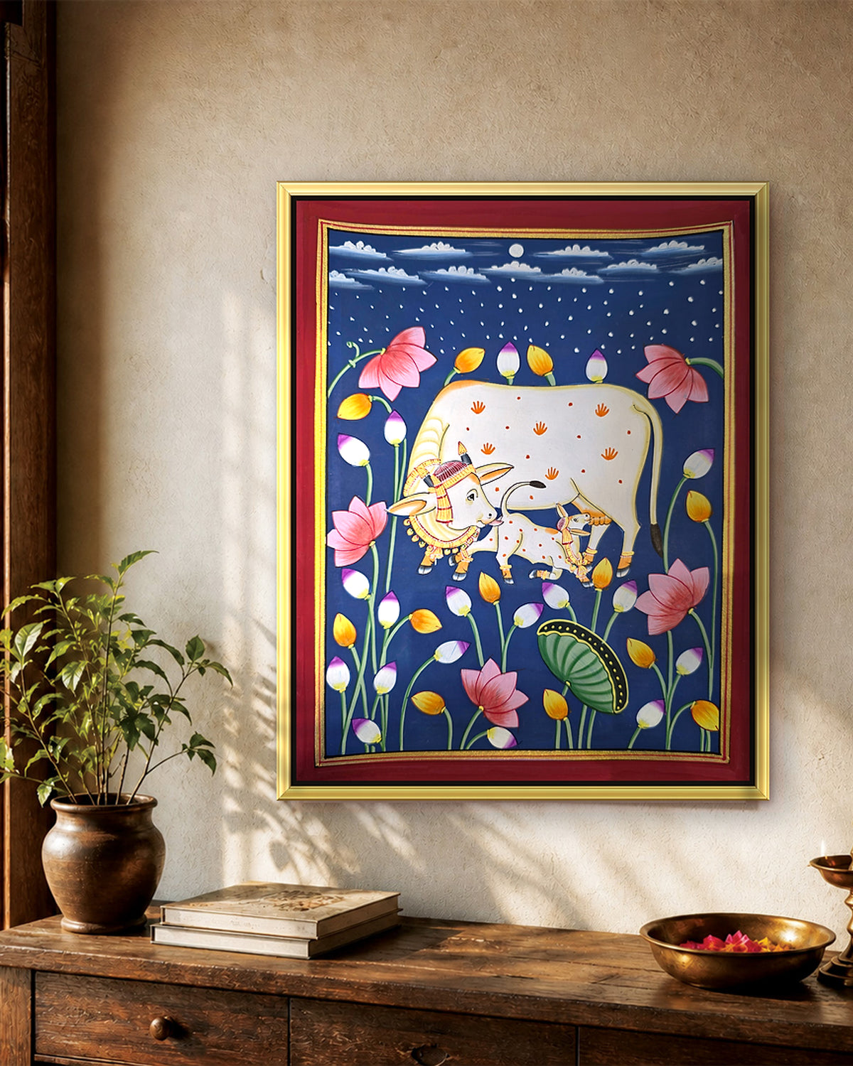 Kamdhenu in the Lotus Pond - Navy Pichwai styled on a wall in a gold metal frame (frame sold separately)