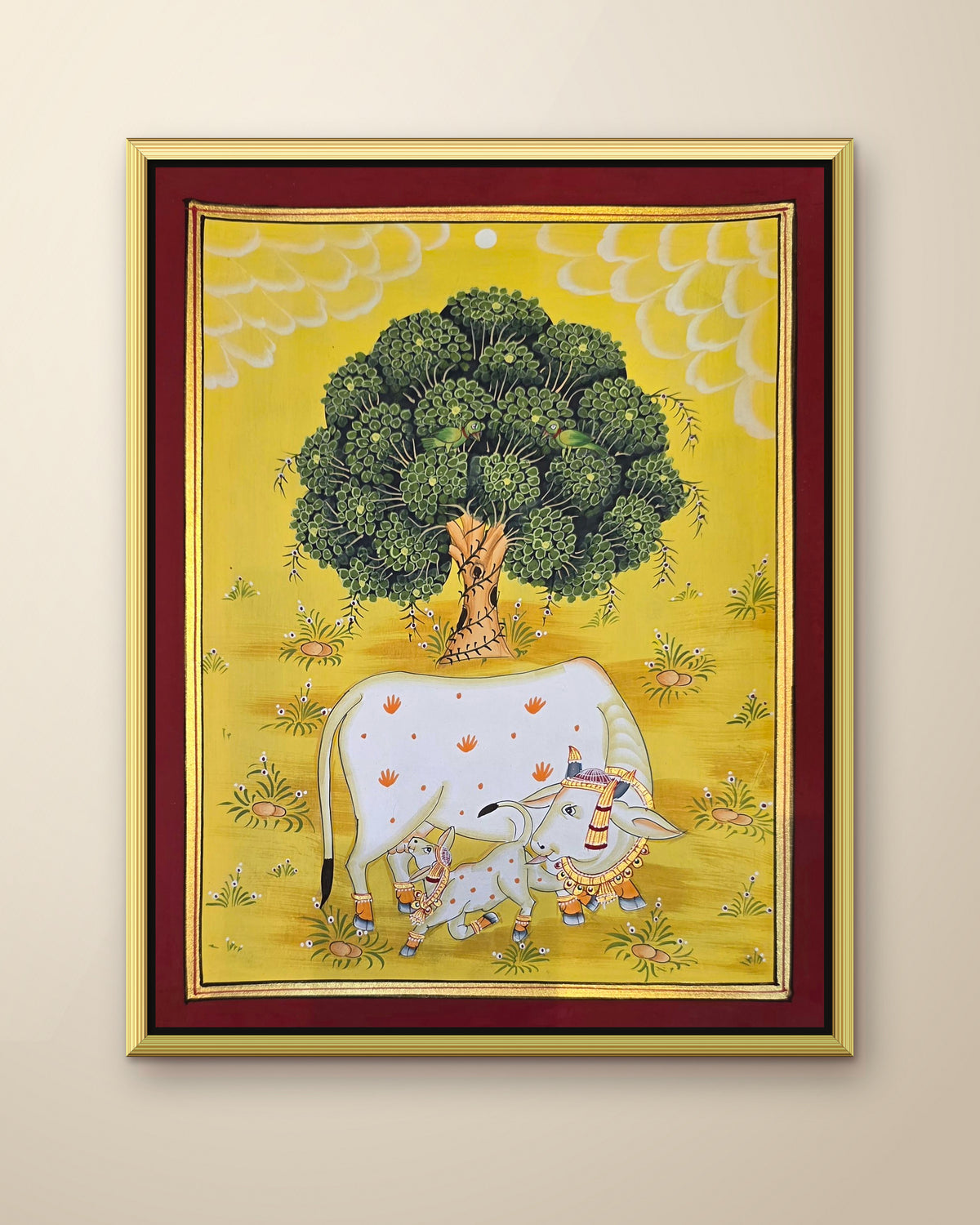 Kamdhenu Under the Kadamb Tree - Yellow Pichwai shown in a gold metal frame (frame sold separately)