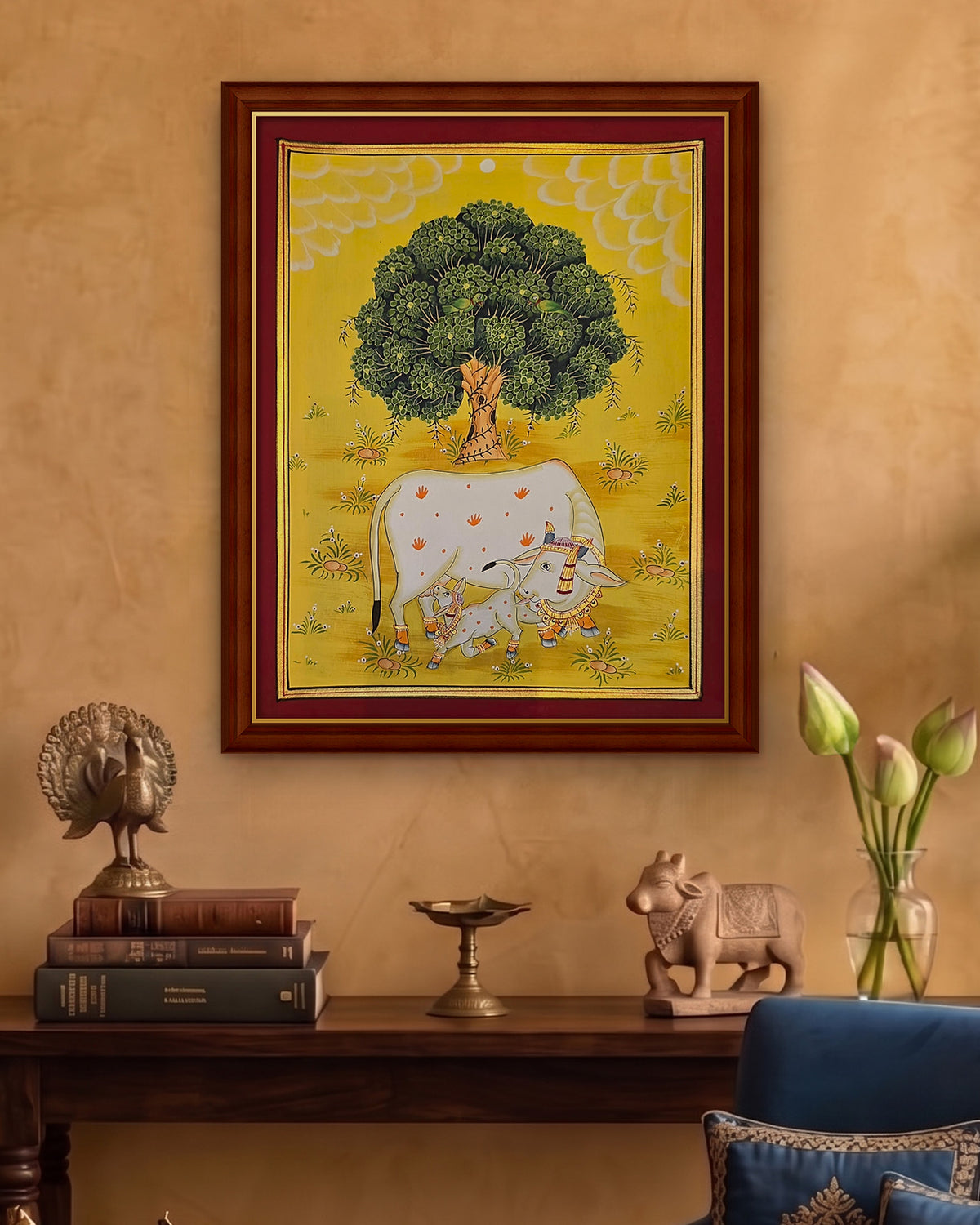 Kamdhenu Under the Kadamb Tree - Yellow Pichwai styled on a wall in a walnut wood frame (frame sold separately)