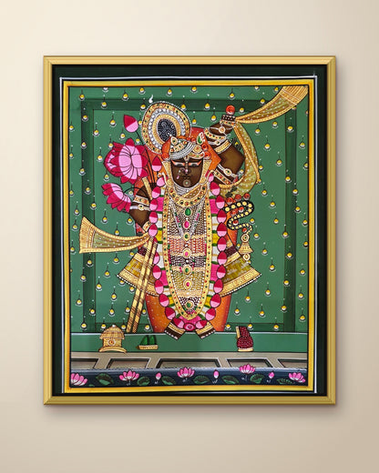 Shrinathji Shringar - Emerald Pichwai shown in a gold metal frame (frame sold separately)