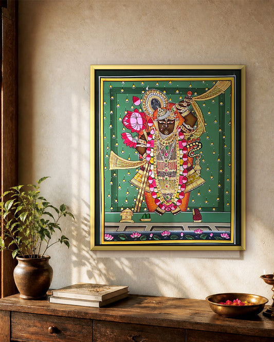 Shrinathji Shringar - Emerald Pichwai styled on a wall in a gold metal frame (frame sold separately)