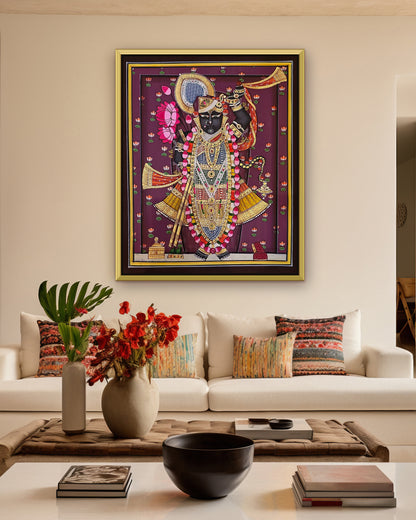 Shrinathji Shringar - Royal Plum Pichwai styled on a wall in a gold metal frame (frame sold separately)