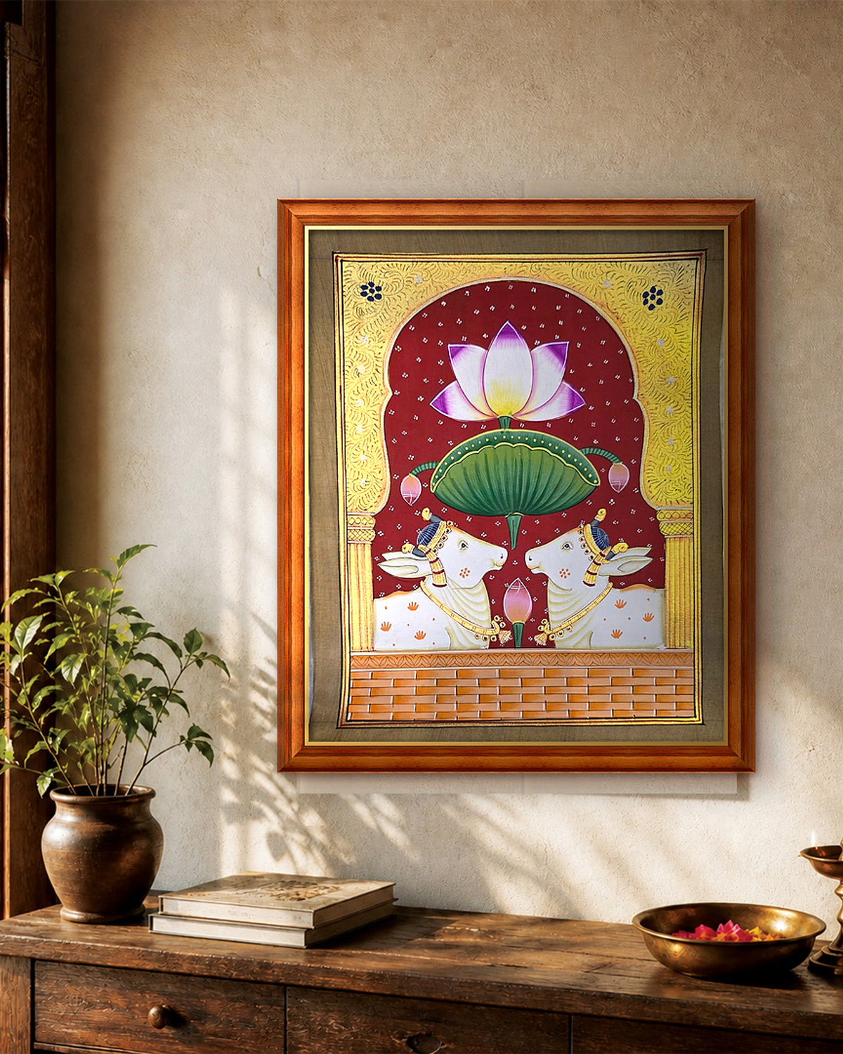 Twin Gaumata Under the Golden Arch - Maroon Pichwai styled on a wall in a teak wood frame (frame sold separately)