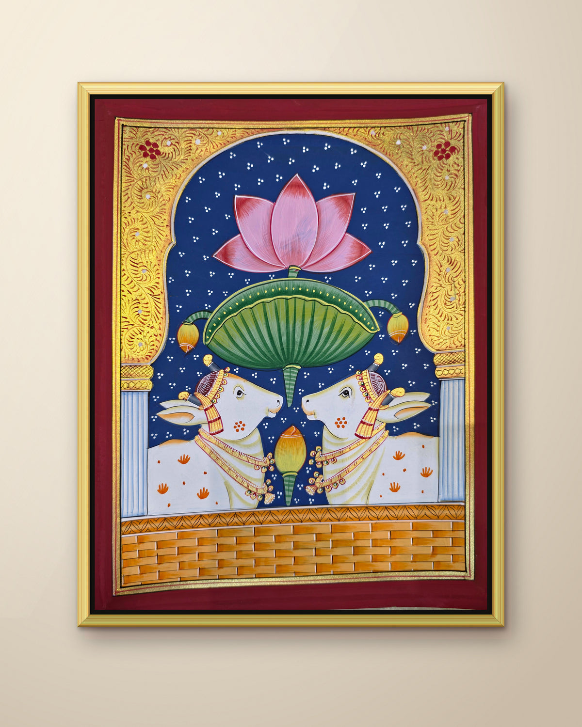 Twin Gaumata Under the Lotus Arch - Navy Pichwai shown in a gold metal frame (frame sold separately)