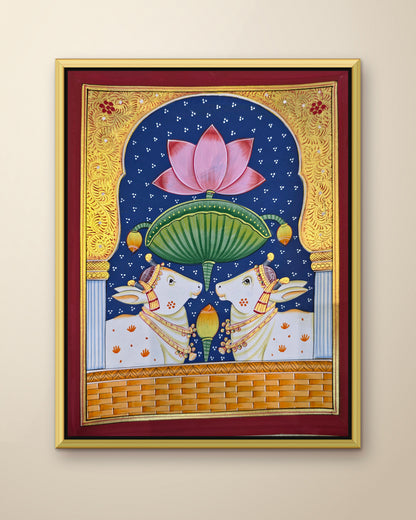 Twin Gaumata Under the Lotus Arch - Navy Pichwai shown in a gold metal frame (frame sold separately)